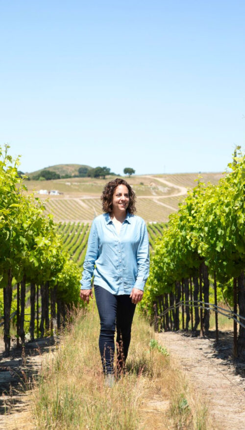 Seaglass winemaker Christine Morrison walks between two rows of vines