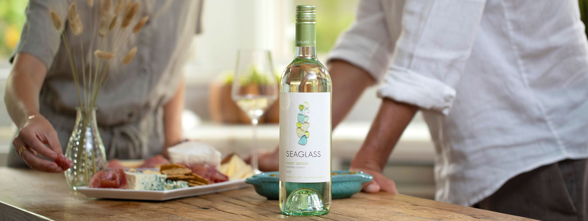 A bottle of Seaglass Pinot Grigio white wine next to a charcuterie and cheese plate