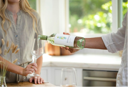 Pouring a glass of Seaglass white wine for a friend