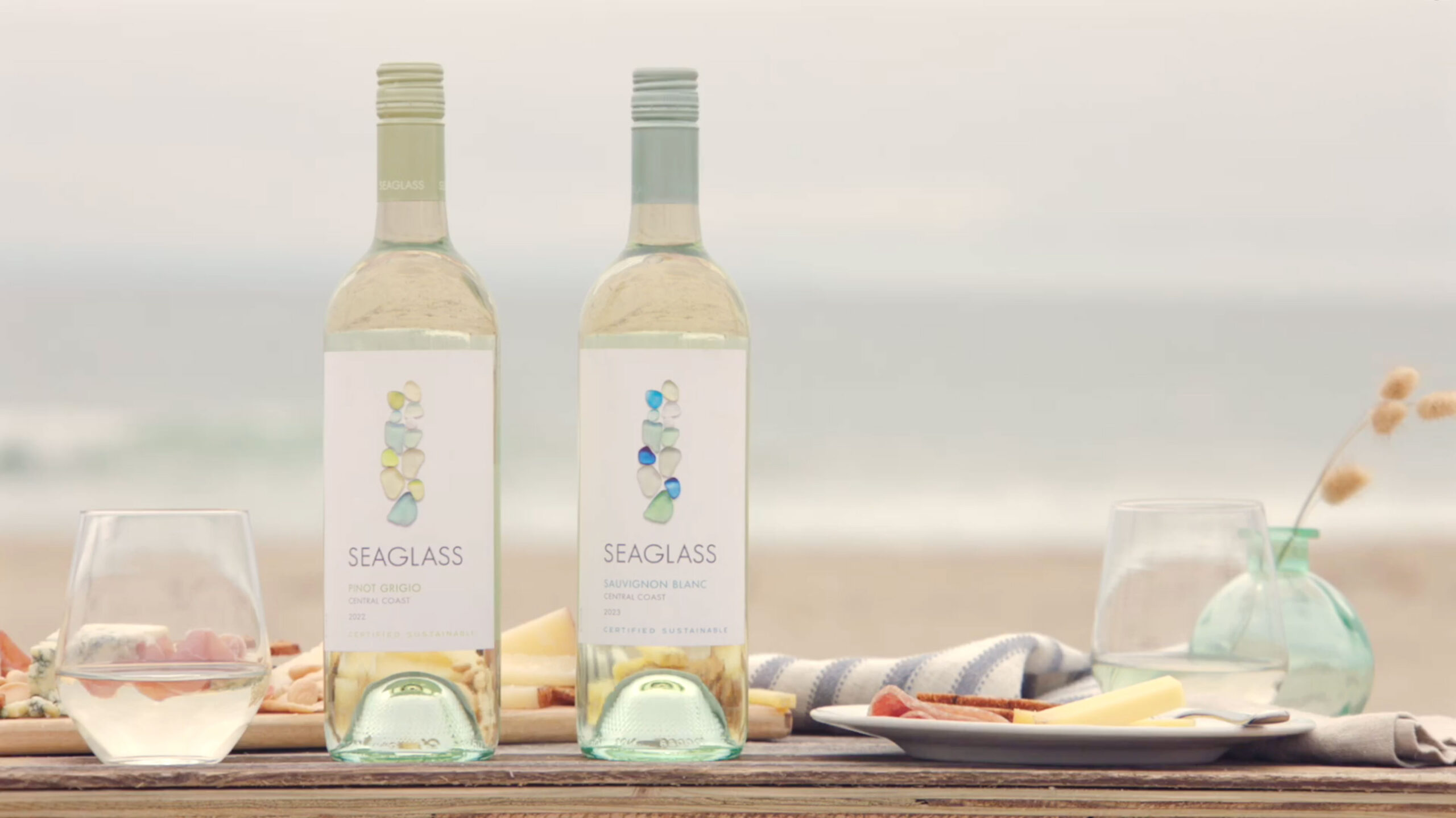 SEAGLASS Pinot Grigio and Sauvignon Blanc bottles on table at the beach